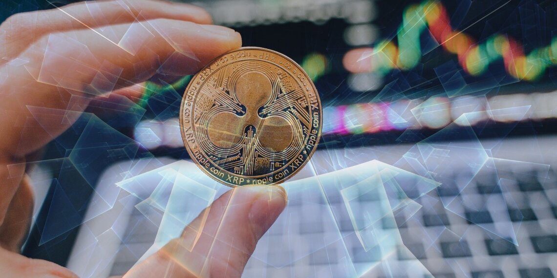A person holding a digital coin XRP.